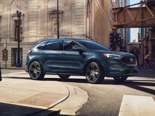 2024 Ford Edge driving around a curb on the street 