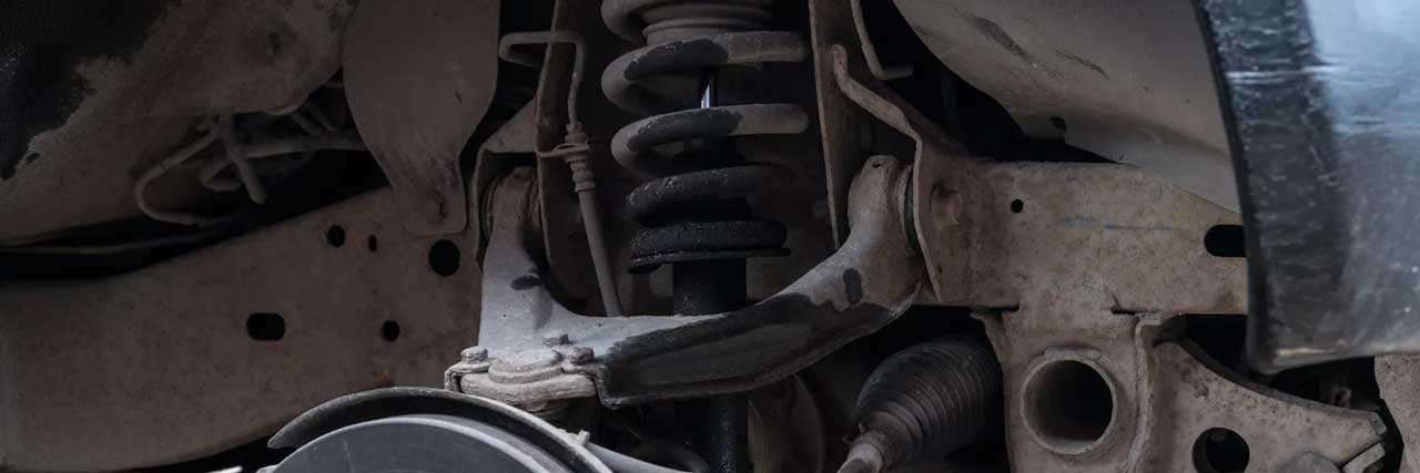 close up view of shocks and struts under a car