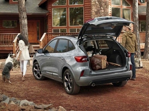 2024 Ford Escape Plug-in Hybrid parked at a cabin with back door open showing cargo area full of bags