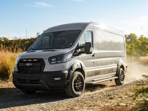 2024 Ford Transit Trail Van driving down a rock road